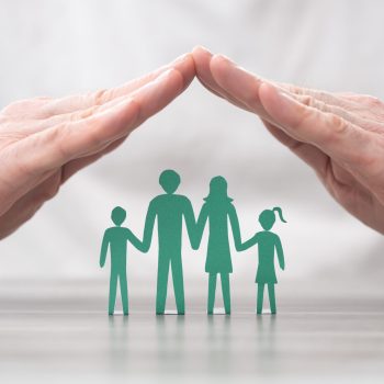 Family protected by hands - Concept of life insurance